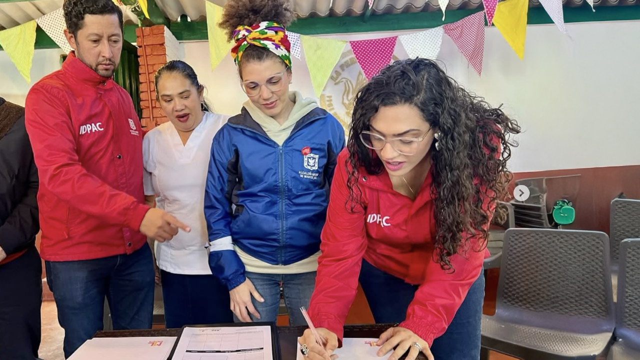 Funcionaria del IDPAC firma acuerdo junto a ciudadanía y representantes institucionales durante jornada de participación y convivencia en Bogotá.