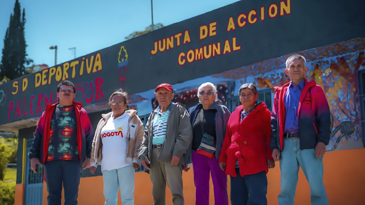 Grupo de integrantes de la Junta de Acción Comunal del barrio Palermo Sur posan frente a su sede comunal en Bogotá.