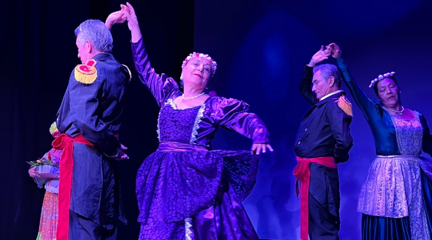 Personas mayores bailando en una presentación cultural, con trajes típicos, durante el evento de los Consejos de Sabias y Sabios en Bogotá.