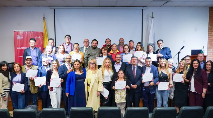 Consejeras y consejeros de las 20 localidades de Bogotá posan con sus certificados durante la instalación del Consejo Distrital de Propiedad Horizontal 2025–2029, en un acto organizado por el IDPAC.